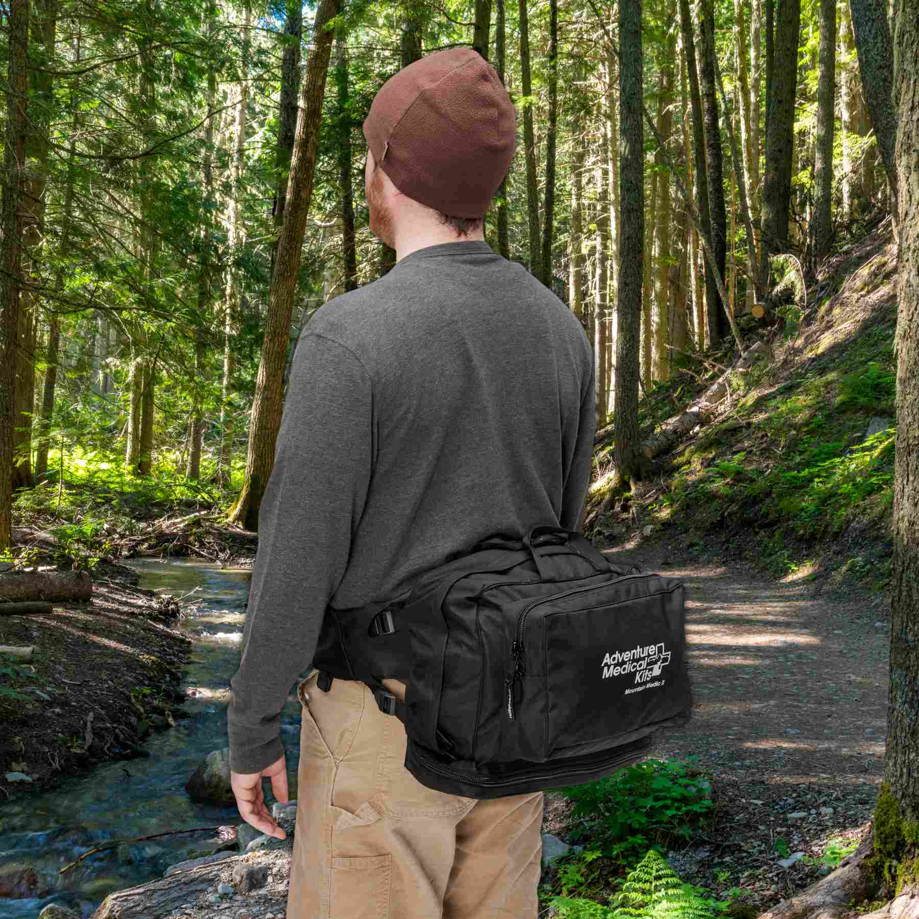 Pro Series Emergency Medical Kit - Mountain Medic II attached to man's waist while hiking