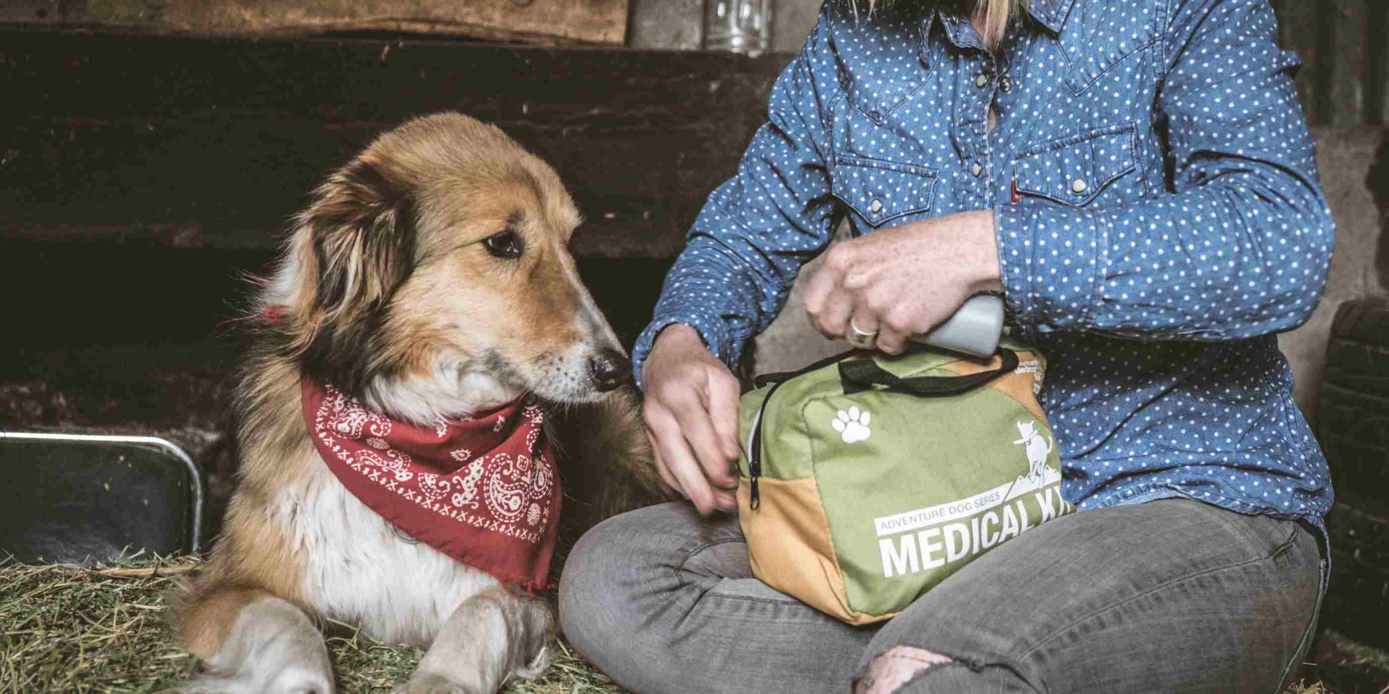 Adventure Dog Medical Kit - Workin' Dog woman opening kit next to dog with red bandana